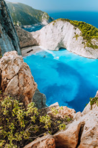 Navagio beach from top rocks at Zakynthos island, Greece. Stranded freightliner ship in unique beautiful blue lagoon and rocky mountains. Navagio beach from top rocks at Zakynthos island, Greece. Stranded freightliner ship in unique beautiful blue lagoon and rocky mountains.